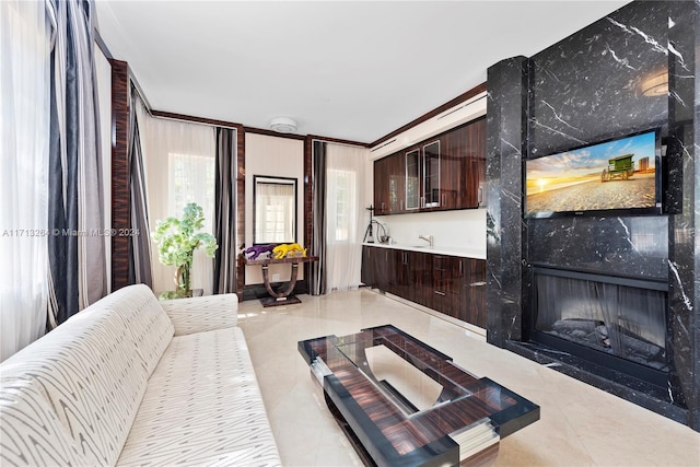 tiled living room featuring a premium fireplace and crown molding