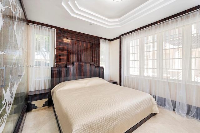 tiled bedroom featuring multiple windows