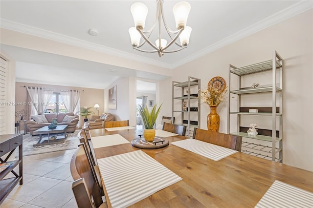 tiled dining area with crown molding and a chandelier