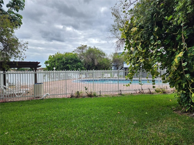 view of pool featuring a lawn