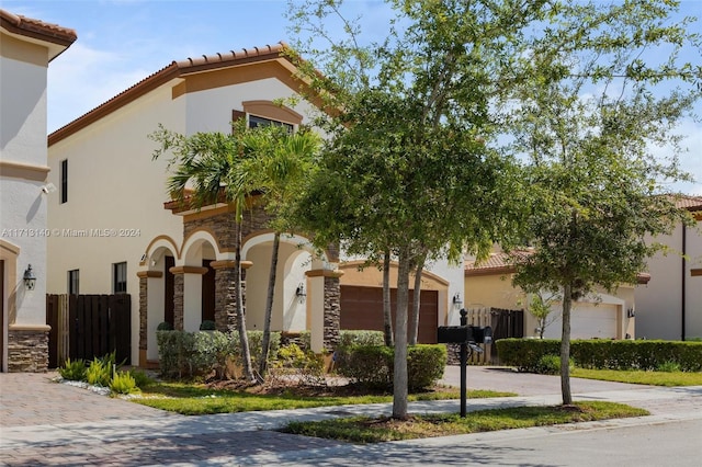 mediterranean / spanish-style home with a garage