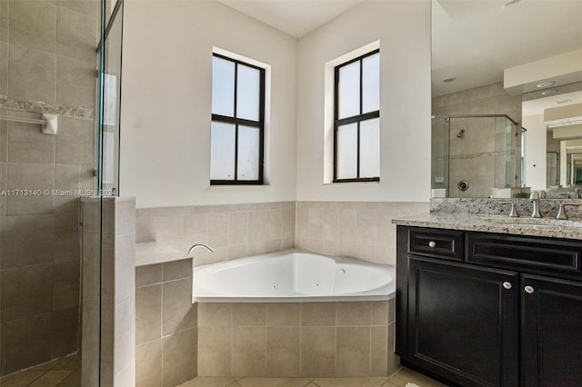 bathroom with tile patterned flooring, vanity, and plus walk in shower