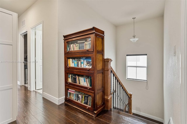 corridor with dark hardwood / wood-style floors