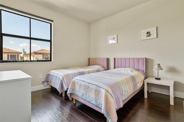 bedroom with dark hardwood / wood-style flooring