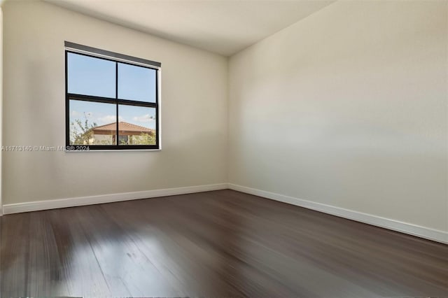 empty room with dark wood-type flooring