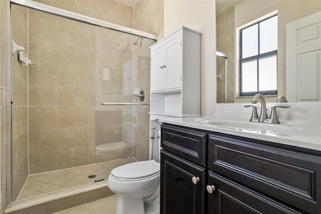 bathroom with tile patterned flooring, vanity, toilet, and walk in shower