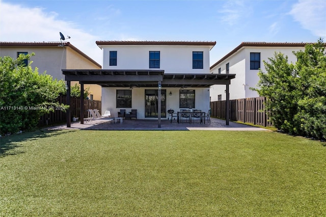 rear view of house featuring a patio and a lawn