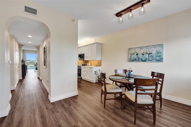 dining space featuring dark hardwood / wood-style flooring