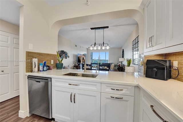 kitchen featuring dark wood-type flooring, sink, white cabinets, and stainless steel dishwasher