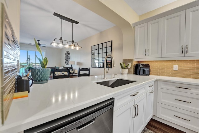 kitchen featuring white cabinetry, stainless steel dishwasher, tasteful backsplash, and sink