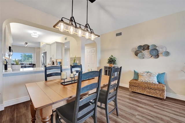 dining area with dark hardwood / wood-style floors