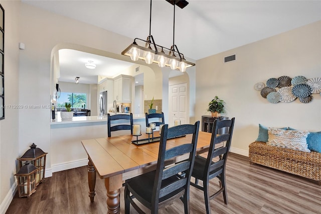 dining space with dark hardwood / wood-style flooring