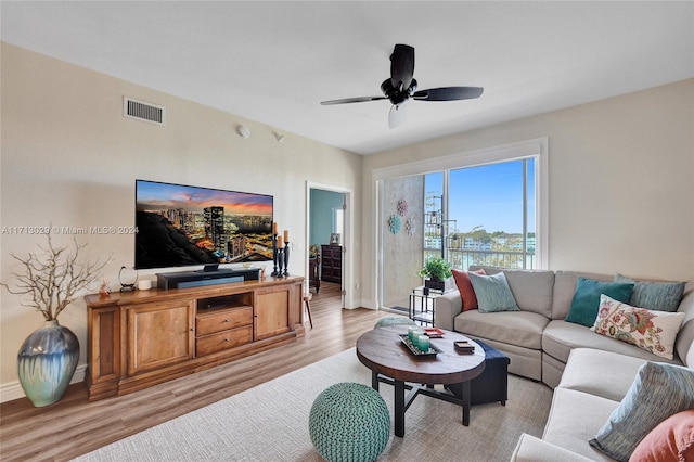 living room with light wood-type flooring and ceiling fan