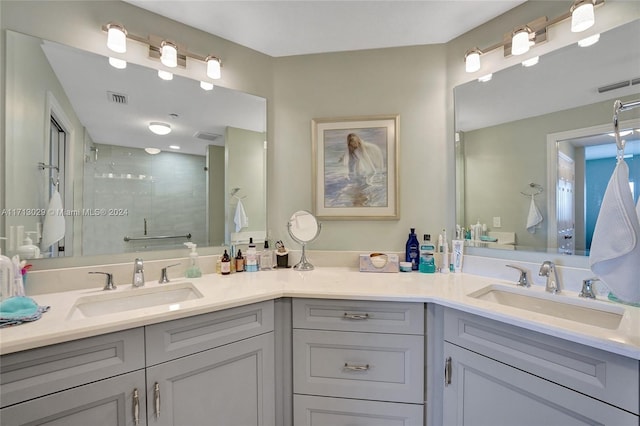 bathroom with vanity and a shower with shower door