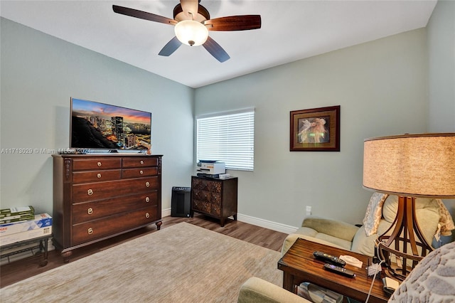 living area featuring ceiling fan and dark wood-type flooring