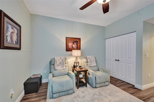 sitting room with hardwood / wood-style flooring and ceiling fan