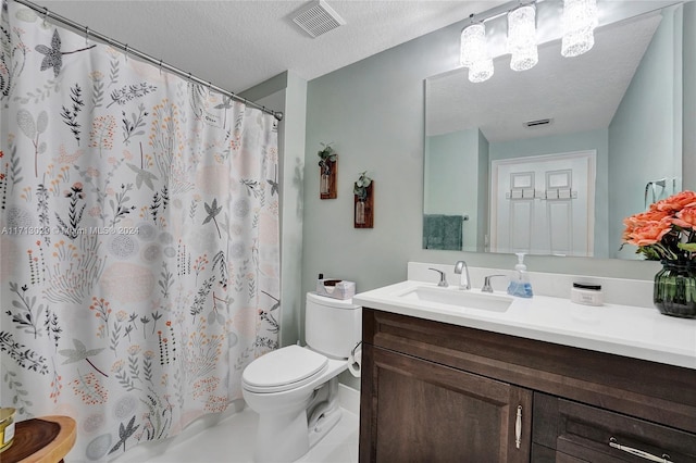 bathroom with a shower with curtain, vanity, toilet, and a textured ceiling