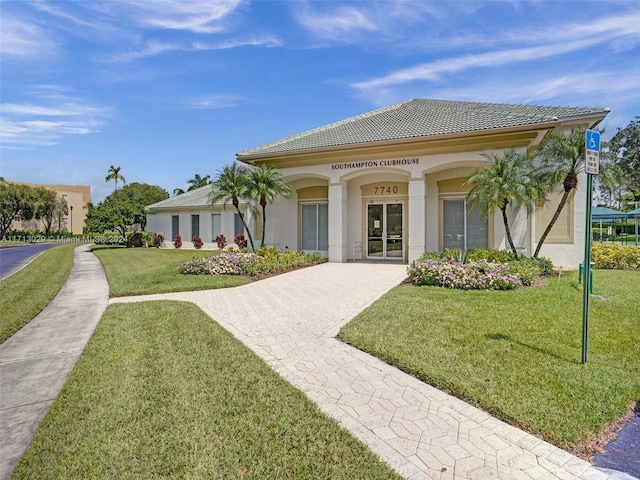 mediterranean / spanish home with a front yard