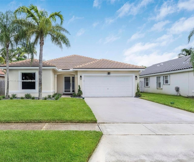 view of front of property featuring a garage and a front lawn