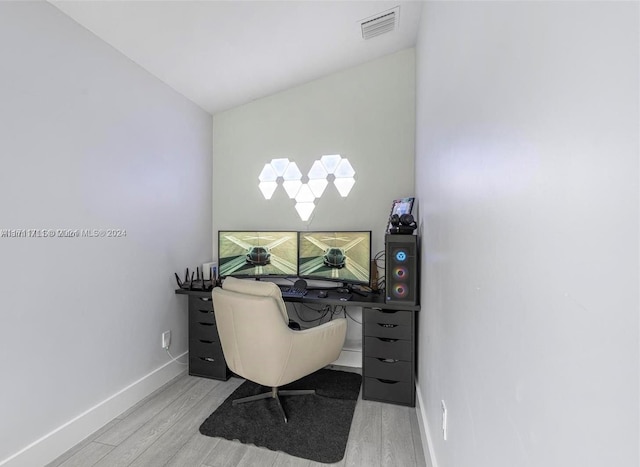 office featuring light hardwood / wood-style flooring and lofted ceiling