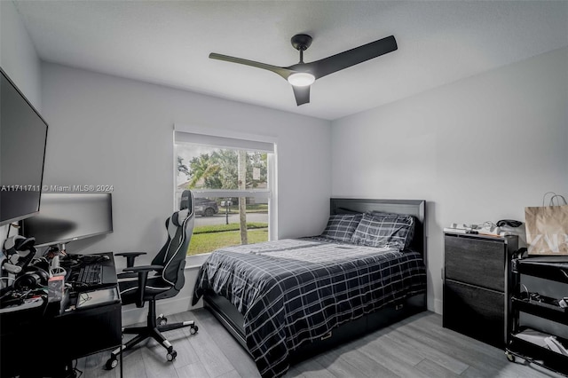 bedroom with ceiling fan and light hardwood / wood-style flooring