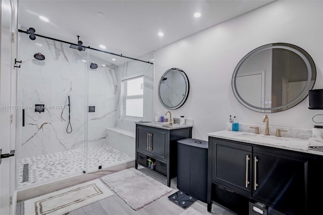 bathroom featuring hardwood / wood-style floors, vanity, and walk in shower