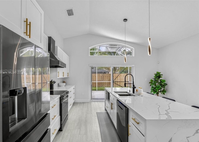 kitchen featuring white cabinets, pendant lighting, wall chimney range hood, and stainless steel appliances