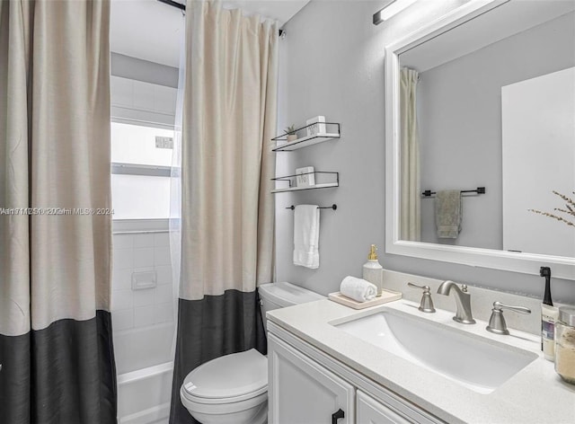 full bathroom with vanity, toilet, and shower / bath combo with shower curtain