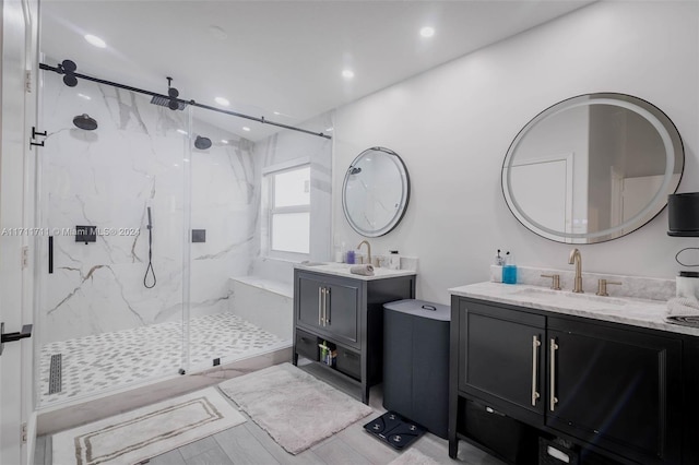 bathroom featuring hardwood / wood-style floors, vanity, and a shower with shower door