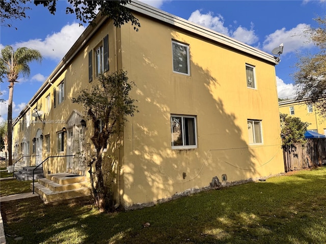 view of side of home featuring a yard