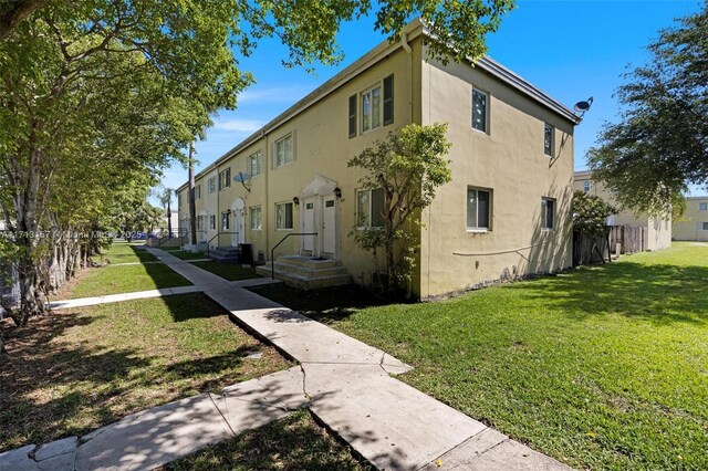 8315 NW 5th Ave Unit 8315, Miami, FL 33150 - view of side of property featuring stucco siding and a yard