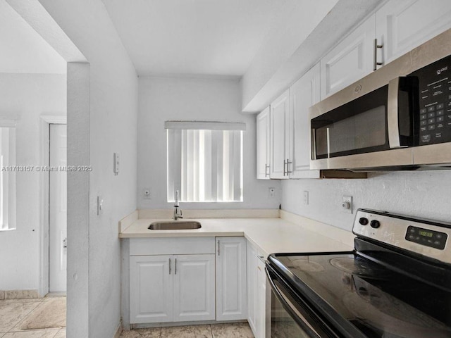 8315 NW 5th Ave Unit 8315, Miami, FL 33150 - kitchen featuring white cabinets, appliances with stainless steel finishes, a sink, and light countertops