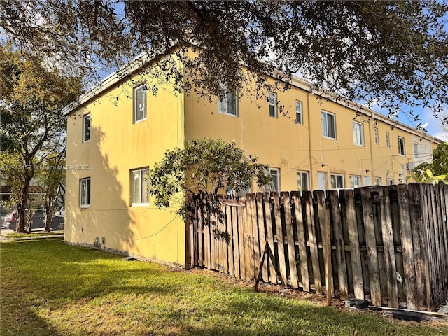 view of side of home with a lawn