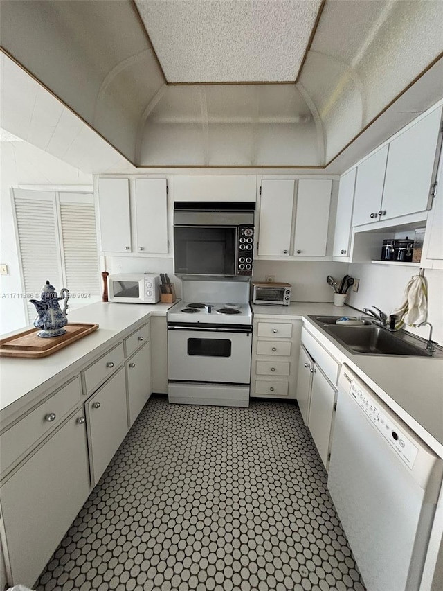 kitchen with white cabinets, a textured ceiling, white appliances, and sink