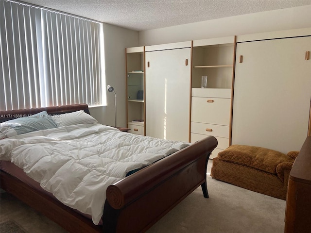 carpeted bedroom with a textured ceiling