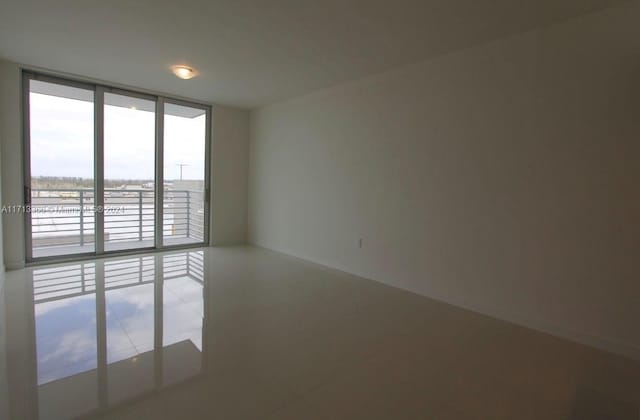 7875 NW 107th Ave Unit 719, Doral, FL 33178 - empty room with a wall of windows