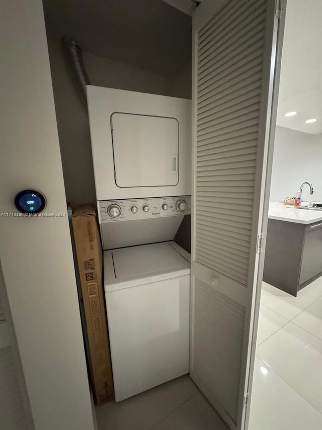 7875 NW 107th Ave Unit 719, Doral, FL 33178 - washroom featuring stacked washing machine and dryer and light tile patterned floors