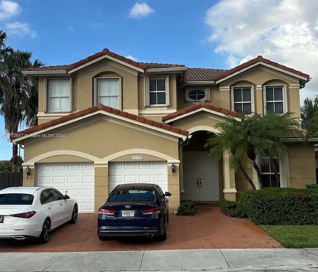 mediterranean / spanish-style house with a garage