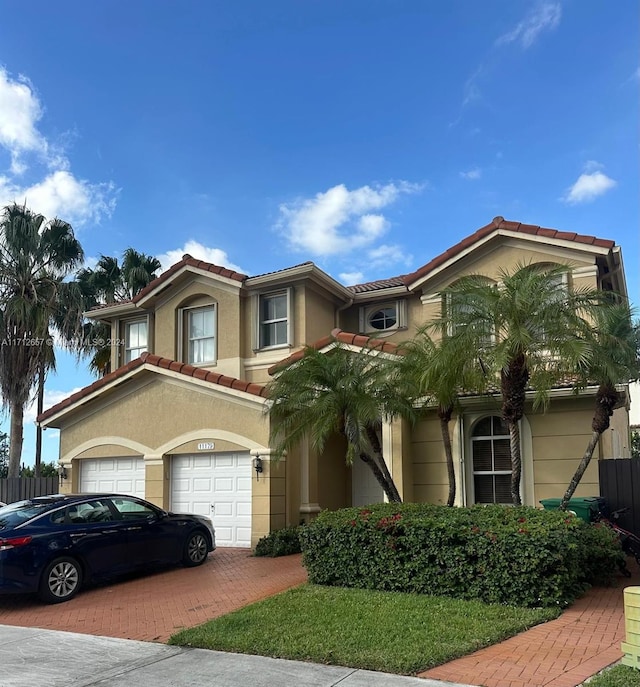 mediterranean / spanish-style home with a garage