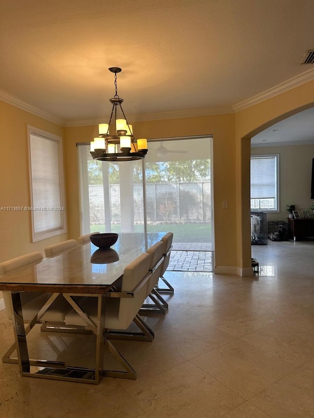 dining space with a notable chandelier and crown molding