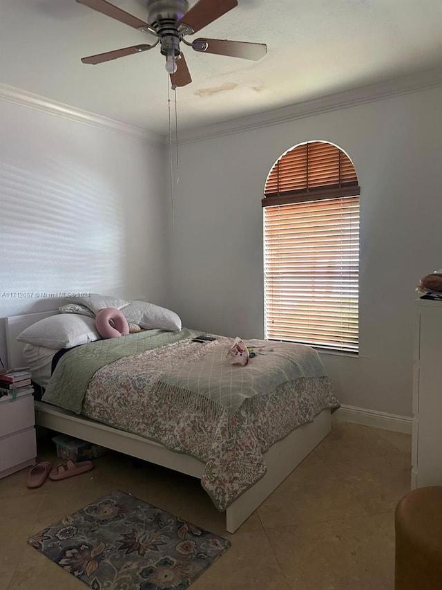 bedroom with ceiling fan and crown molding