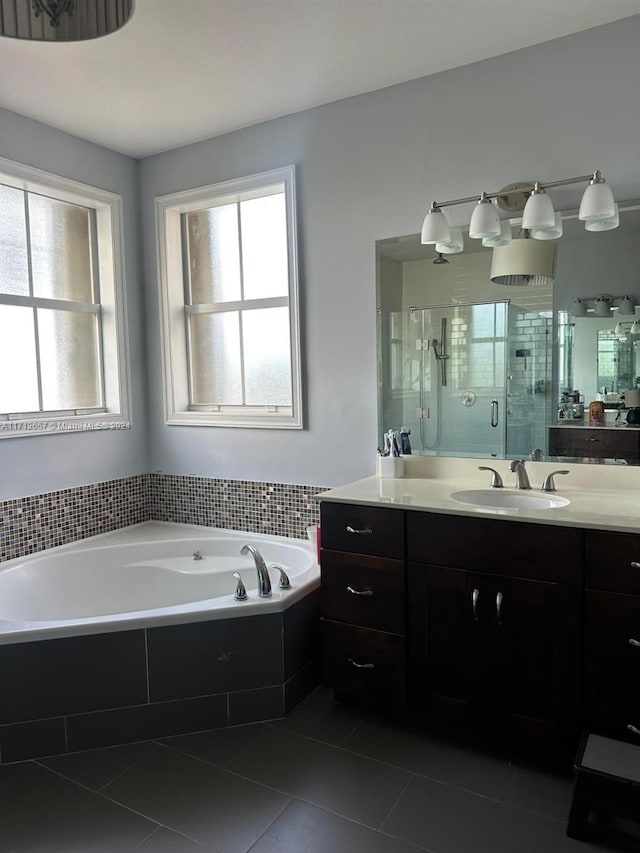 bathroom with plus walk in shower, tile patterned flooring, and vanity