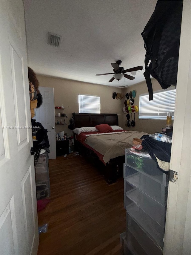 bedroom with ceiling fan and dark hardwood / wood-style floors