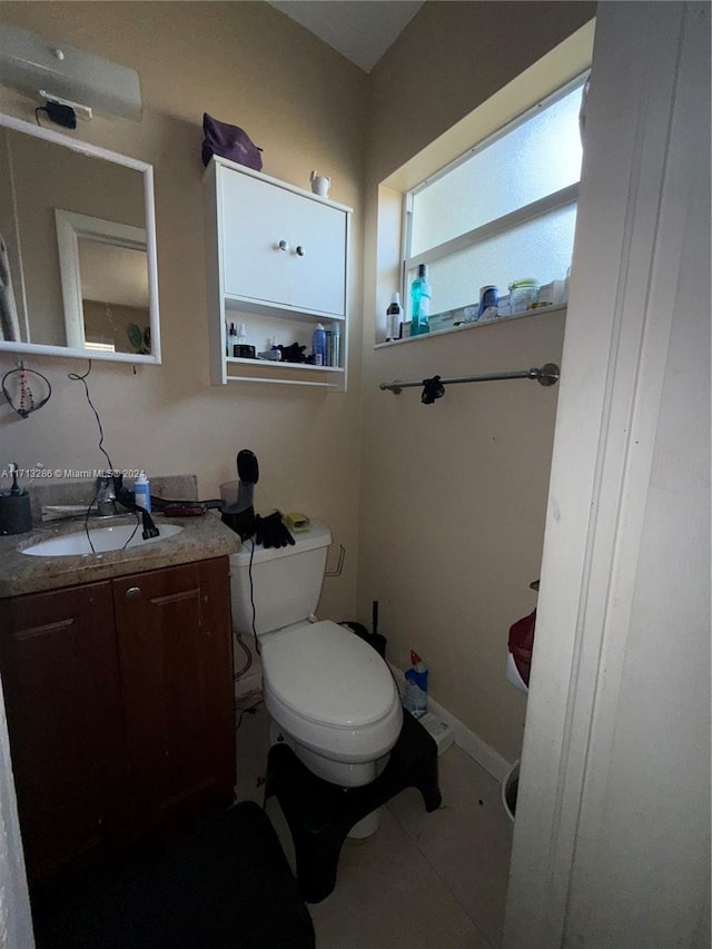 bathroom with tile patterned flooring, vanity, and toilet