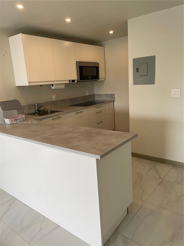 kitchen featuring kitchen peninsula, black electric stovetop, sink, white cabinets, and electric panel