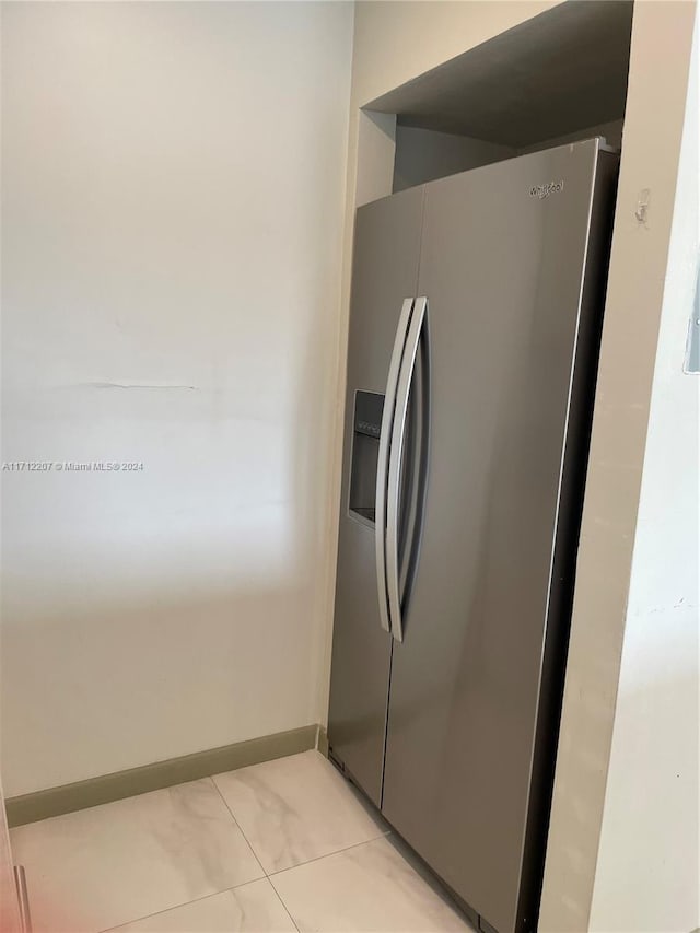 kitchen with stainless steel refrigerator with ice dispenser and light tile patterned floors