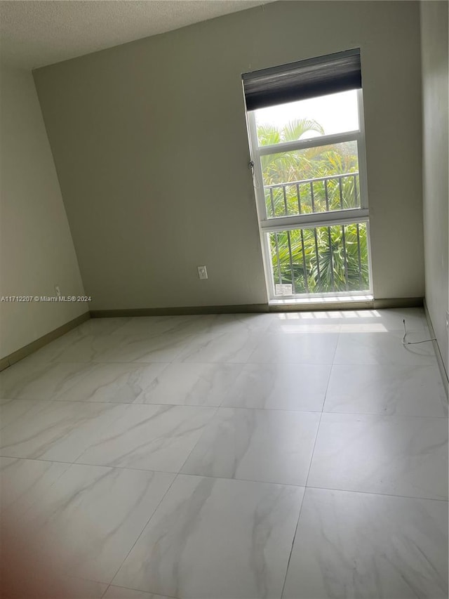 spare room with a textured ceiling