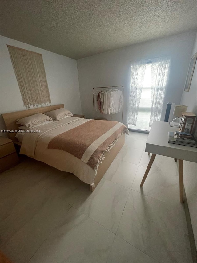 bedroom featuring a textured ceiling