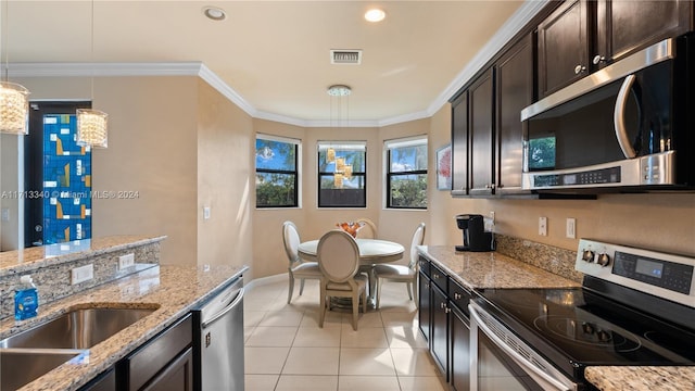 kitchen featuring hanging light fixtures, stainless steel appliances, light stone counters, dark brown cabinets, and ornamental molding