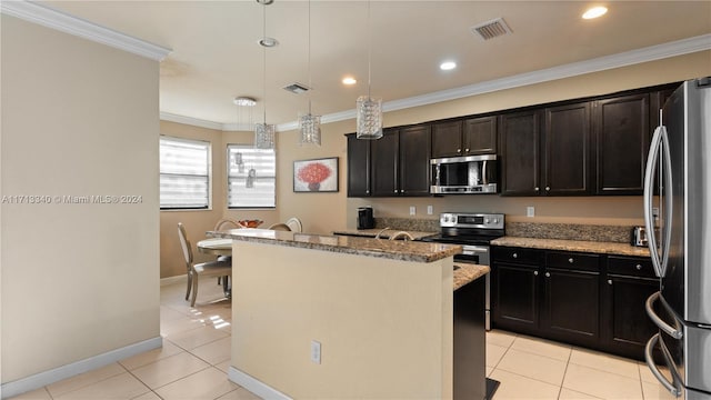 kitchen featuring pendant lighting, a center island, light stone countertops, ornamental molding, and appliances with stainless steel finishes